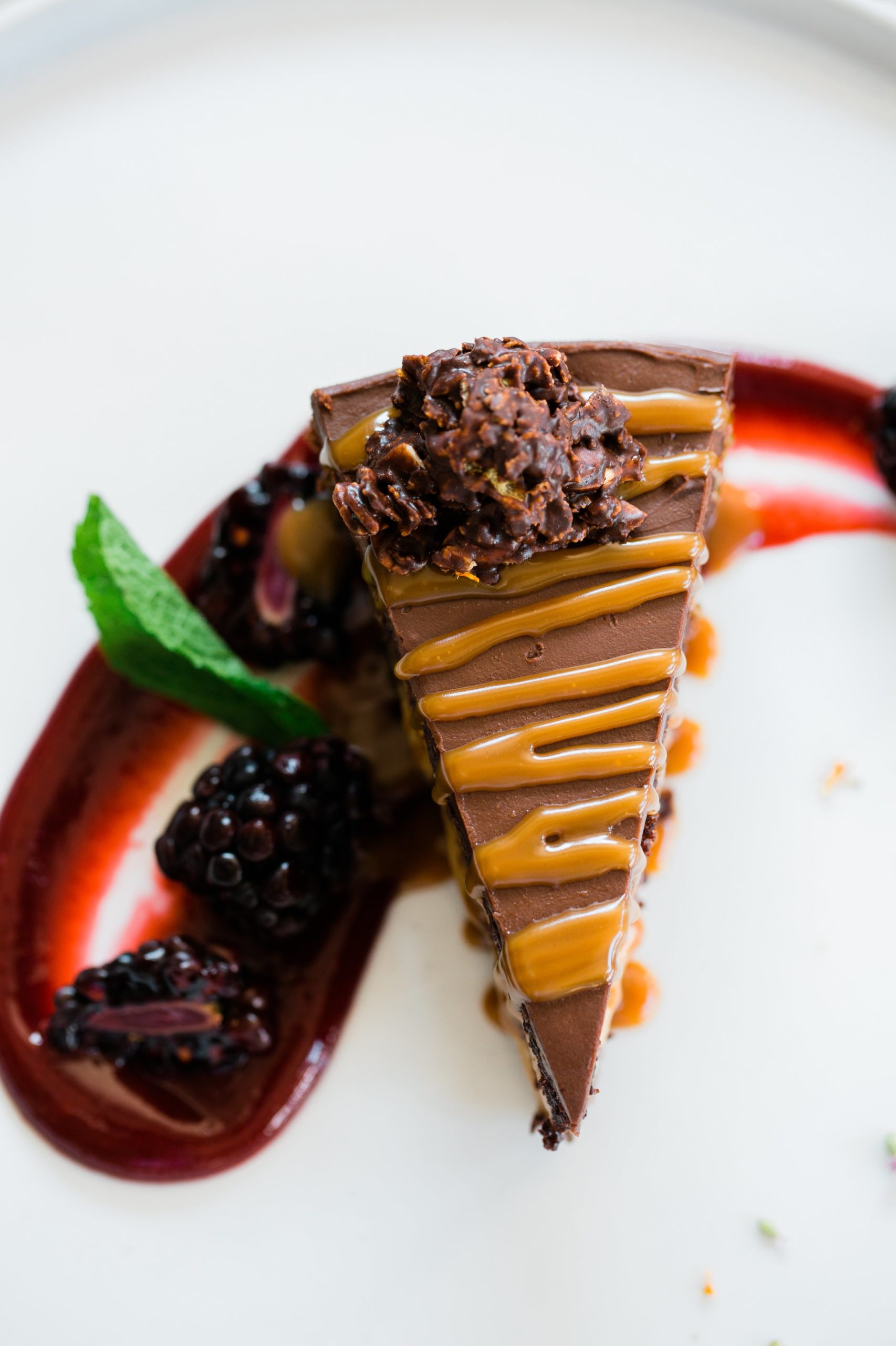 chocolate cake with a toffee swirl and raspberry coulis